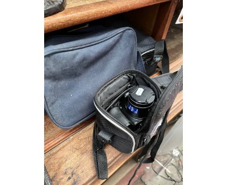A group of four digital cameras comprising Fujifilm, Kodak, Samsung, and a Canon video recorder, together with a portable DVD