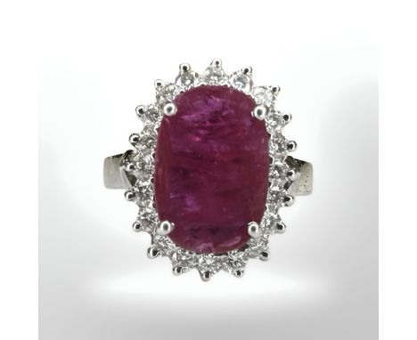 An 18ct white gold ruby and diamond cluster ring, the oval-cut ruby with a border of twenty brilliant-cut diamonds in claw se