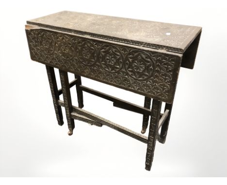 A Victorian heavily carved and ebonised drop leaf gate leg table, width 76 cm 
