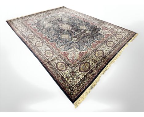 A machine made carpet of Iranian Kirman design, 417 cm x 300 cm.