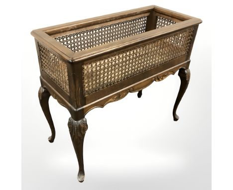 An early 20th century beech and cane work planter on cabriole legs, width 73 cm.