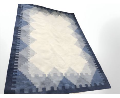 A flat weave kilim carpet on blue ground, 310 cm x 205 cm 