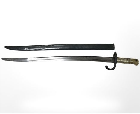 A French Remington sabre bayonet with brass hilt and steel scabbard, blade 57 cm, for the Remington rolling block rifle