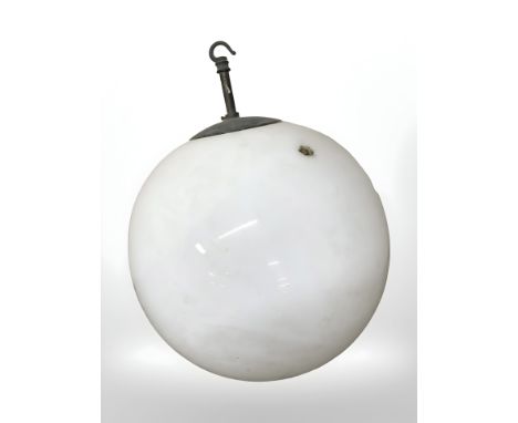 A 20th century opaque glass globular light shade with metal hanger, diameter 31 cm.
