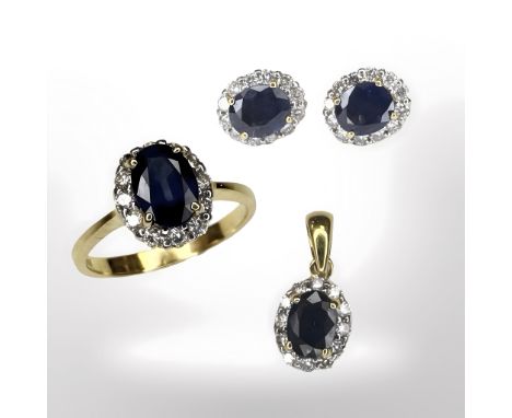 An 18ct gold sapphire and diamond cluster ring with matching pendant on pair of earrings ensuite, ring size K. CONDITION REPO