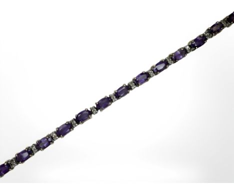 A 14ct gold amethyst and diamond line bracelet, length 18cm CONDITION REPORT: 8g