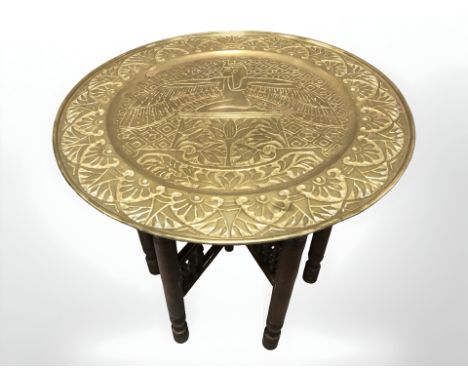 An embossed brass bobbin turned occasional table with Egyptian themed top, diameter 56 cm.