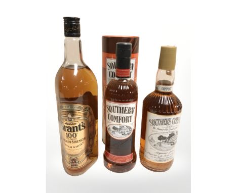 A bottle of Grant's superior strength scotch whisky, 1000ml, and two further bottles of Southern Comfort, one in carton.