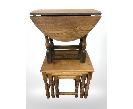 An oak barley twist nest of tables, small drop leaf table and a commode stool 