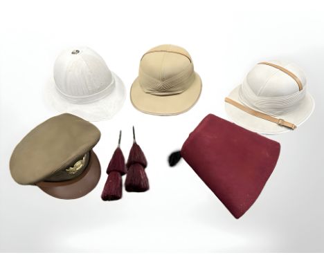 A 'Comfortease' khaki tropical helmet, a further Comfortease pith tropical helmet, another pith helmet with inscription to in