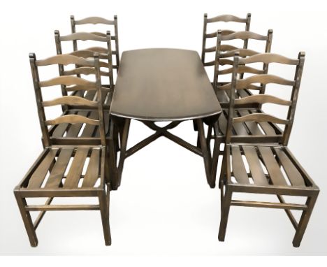 An Ercol stained elm drop leaf dining table and six ladder back chairs 