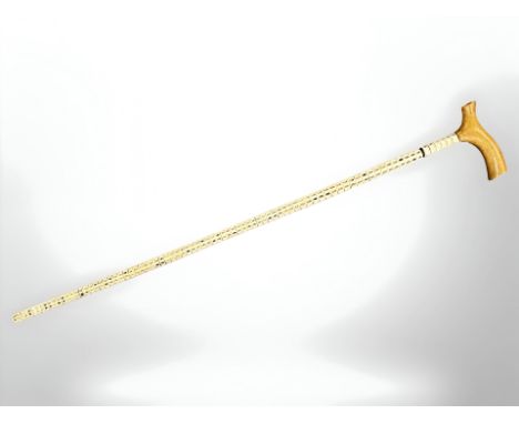 A shark vertebrae walking stick, with wooden handle, length overall 86 cm. 