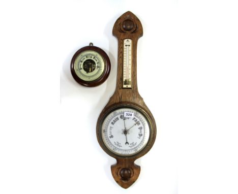 An oak banjo barometer and a further barometer.