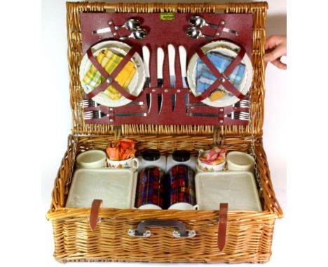 A vintage picnic basket and contents.