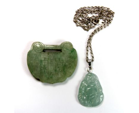 An early 20th century carved jade buckle and a jade Buddha on a silver chain.