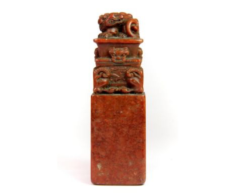 An interesting Chinese carved red hardstone scholar's seal, H. 12.5cm.