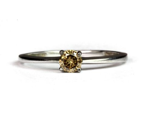 A 9ct white gold (stamped 375) ring set with a brilliant cut fancy light brown diamond (N.5).