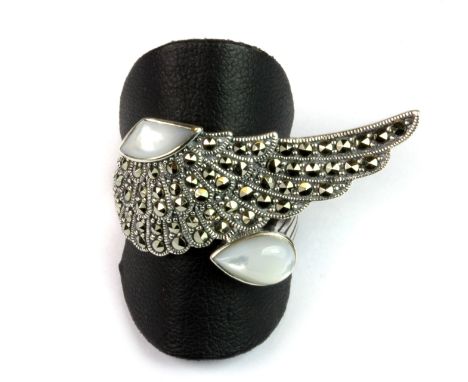 A Luke Stockley 925 silver and marcasite mother of pearl set ring (R).