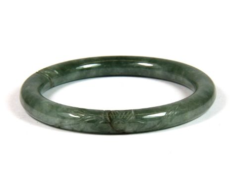 A Chinese carved jade bangle, internal Dia. 5.2cm.