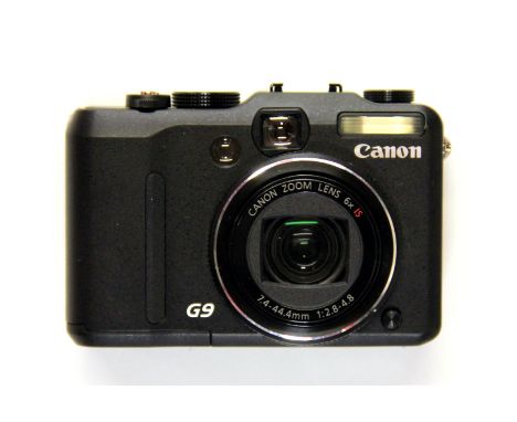 A boxed Canon Powershot G9 camera with charger and other accessories. Please note this is a credit card reclaim item sold as 