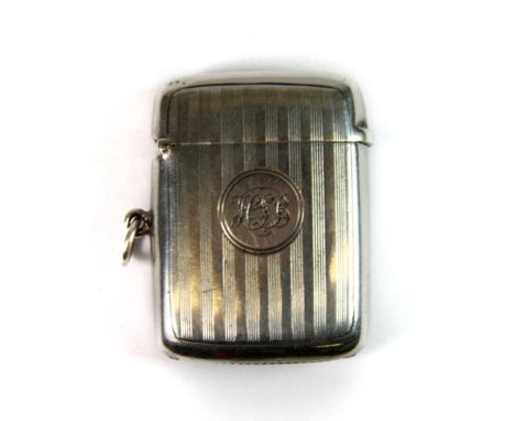 A hallmarked silver vesta with engine turned decoration and engraved initials.