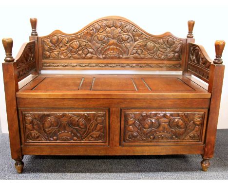 A carved mahogany monks bench style chest, 100 x 50 x 77cm.