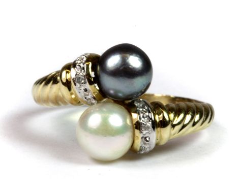 A 14ct yellow gold (worn mark 585) ring set with a white and black pearl and diamonds, (R).