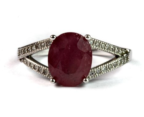 A 925 silver ring set with a natural oval cut ruby and white stones (P.5).