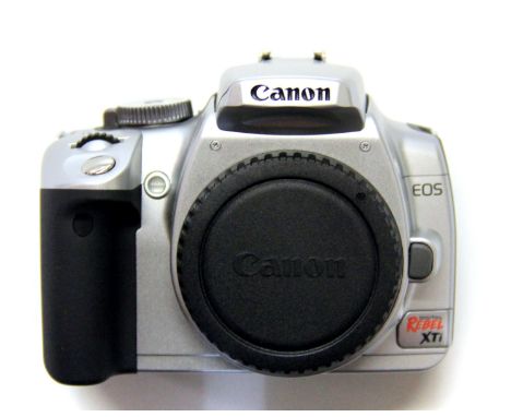 A boxed Canon Rebel XTI camera and charger. Please note this is a credit card reclaim item sold as seen and without reserve.