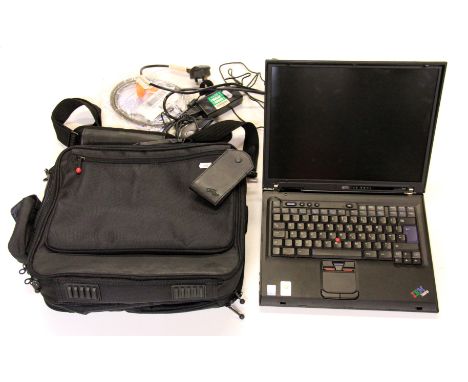 An IBM laptop with its corresponding charger and a carrying case. Please note this is a credit card reclaim item sold as seen