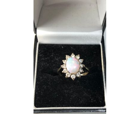 9ct gold opal ring with paste stones around good condition 