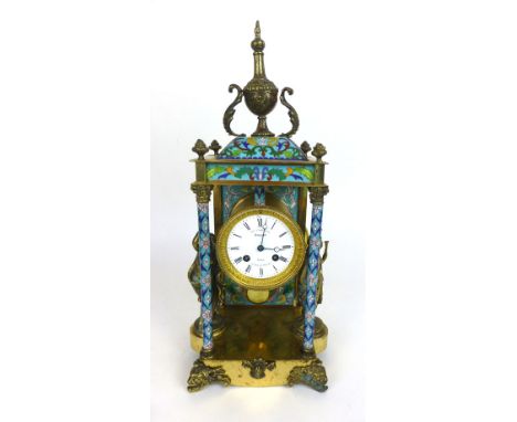 A late 19th century and later mantel clock, the movement striking on a bell, the enamelled face with Roman numerals and label