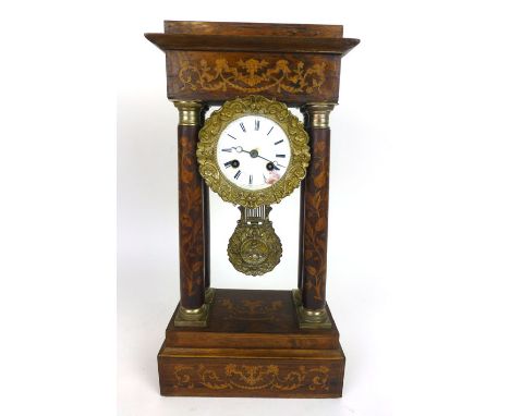 An early 19th century rosewood, marquetry and brass mounted eight day mantle clock, with four columns flanking the enameled f