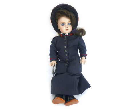 A reproduction Edwardian style doll, composite head with blue glass eyes, brown wig, composite poseable body in a Salvation A