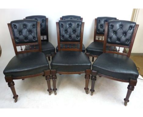 A set of six Edwardian mahogany and black leather upholstered dining chairs, the buttoned backs above spindles over turned an
