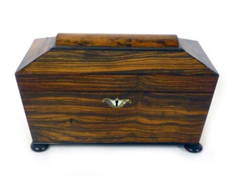 A Regency coramandal sarcophagus form tea caddy with a brass mother of pearl and abalone escutcheon, the top lifting to revea