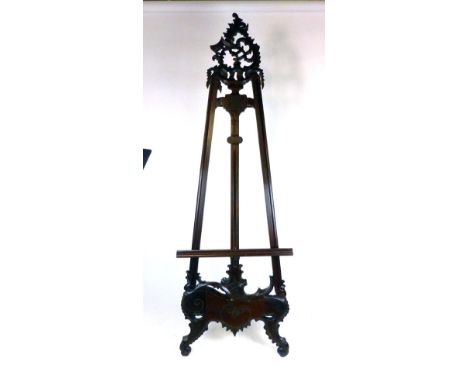 A modern mahogany easel, in the Rococo style with an adjustable shelf, h. 215 cm. w. 70 cm CONDITION REPORT: General wear and