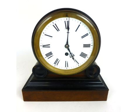 An early 19th century walnut and ebonised thirty hour mantle clock, the enameled face with Roman numerals behind circular bev