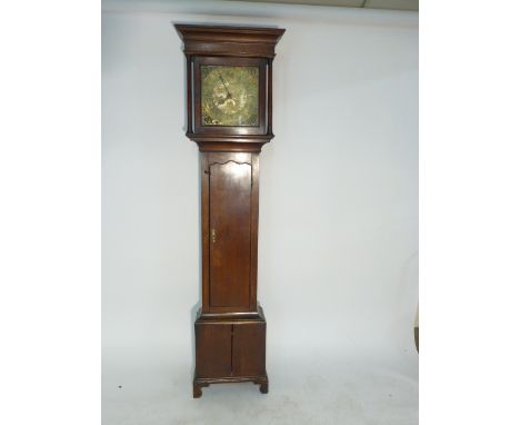 An 18th century oak longcase clock, the brass face having spandrels, pierced hands, date aperture and Roman numerals, the cas