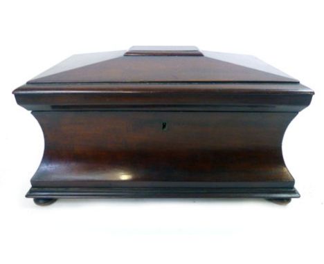 A Victorian mahogany concave sarcophagus tea caddy with fitted interior, ring handles on square bun feet, h. 19 cm, w. 38 cm,