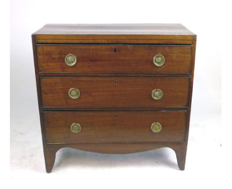 A late George III mahogany chest of drawers, the three graduated and cockbeaded drawers over a shaped apron and tapering legs
