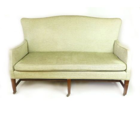 An Edwardian Georgian-style mahogany and green cut fabric three seater sofa, with a shallow arched top rail and square taperi