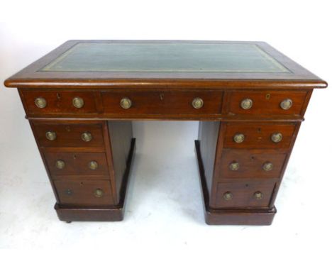 A Victorian mahogany pedestal desk with tooled green leather inserts, having three drawers over two banks of three drawers ab