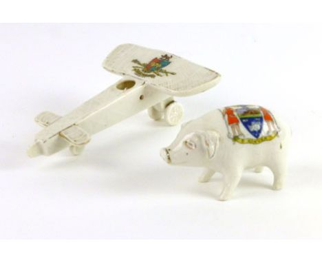 A Clarence Crested Ware model of a First World War aeroplane, together with a Florentine China pig (2) CONDITION REPORT: Wear