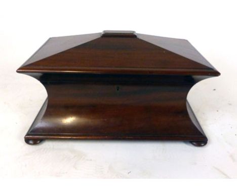 A Victorian mahogany concave sarcophagus tea caddy, the lid lifting to reveal fitted interior with two lidded caddies and mix