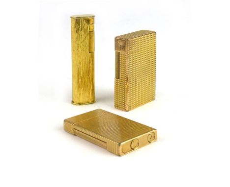 Three lighters to include a Dunhill lighter of ovoid shape together with two St DuPont Paris lighters (3) CONDITION REPORT: N