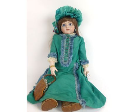 A large bisque headed doll, stamped BRU.JNE 13 BTS 1993, in vintage green clothing and hat, ceramic composite body, fixed blu