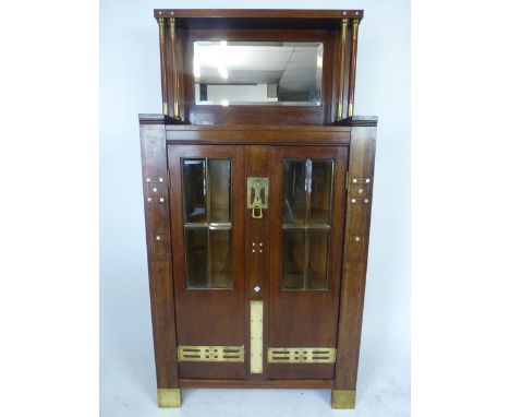 A late 19th/early 20th century Jugendstil mahogany, brass mounted, glazed and mother of pearl inlaid cabinet, the beveled gla