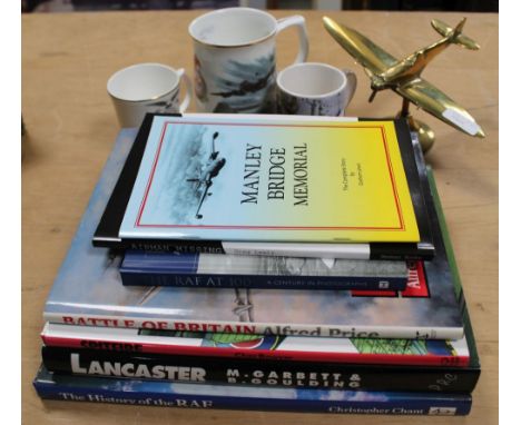 A SELECTION OF RAF MEMORABILIA to include; books, pamphlets, mugs and a brass desk top model of a Spitfire 