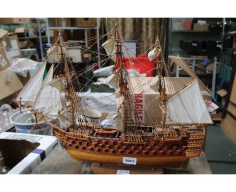A SMALL HAND CARVED WOODEN MODEL GALLEON 